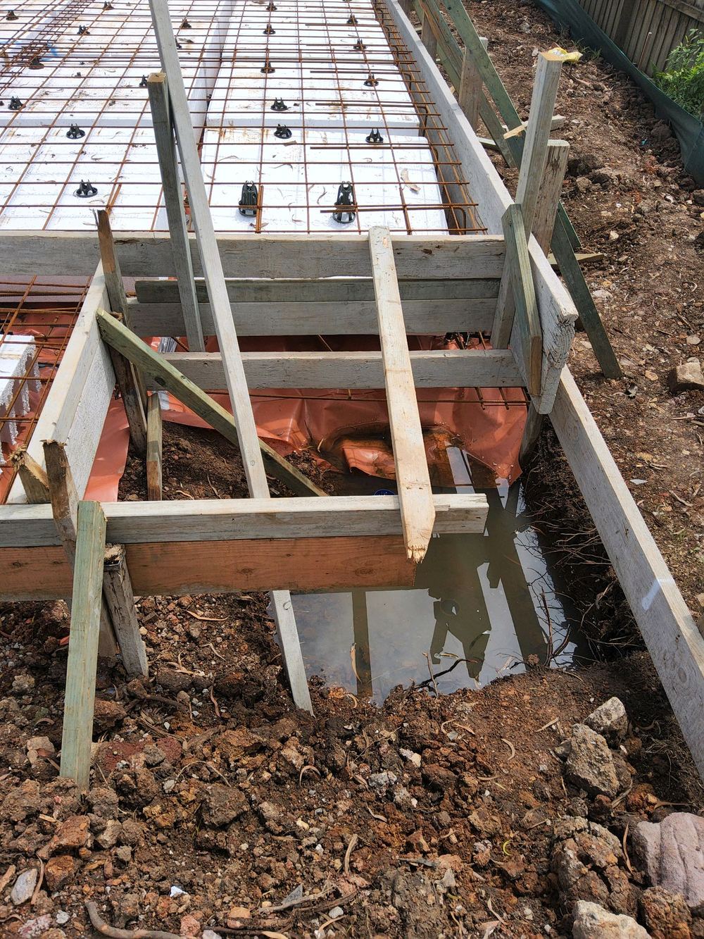 Controlled fill under the edge beam stopping short of the 1 m required, found during a slab pre-pour inspection in Pennant Hills