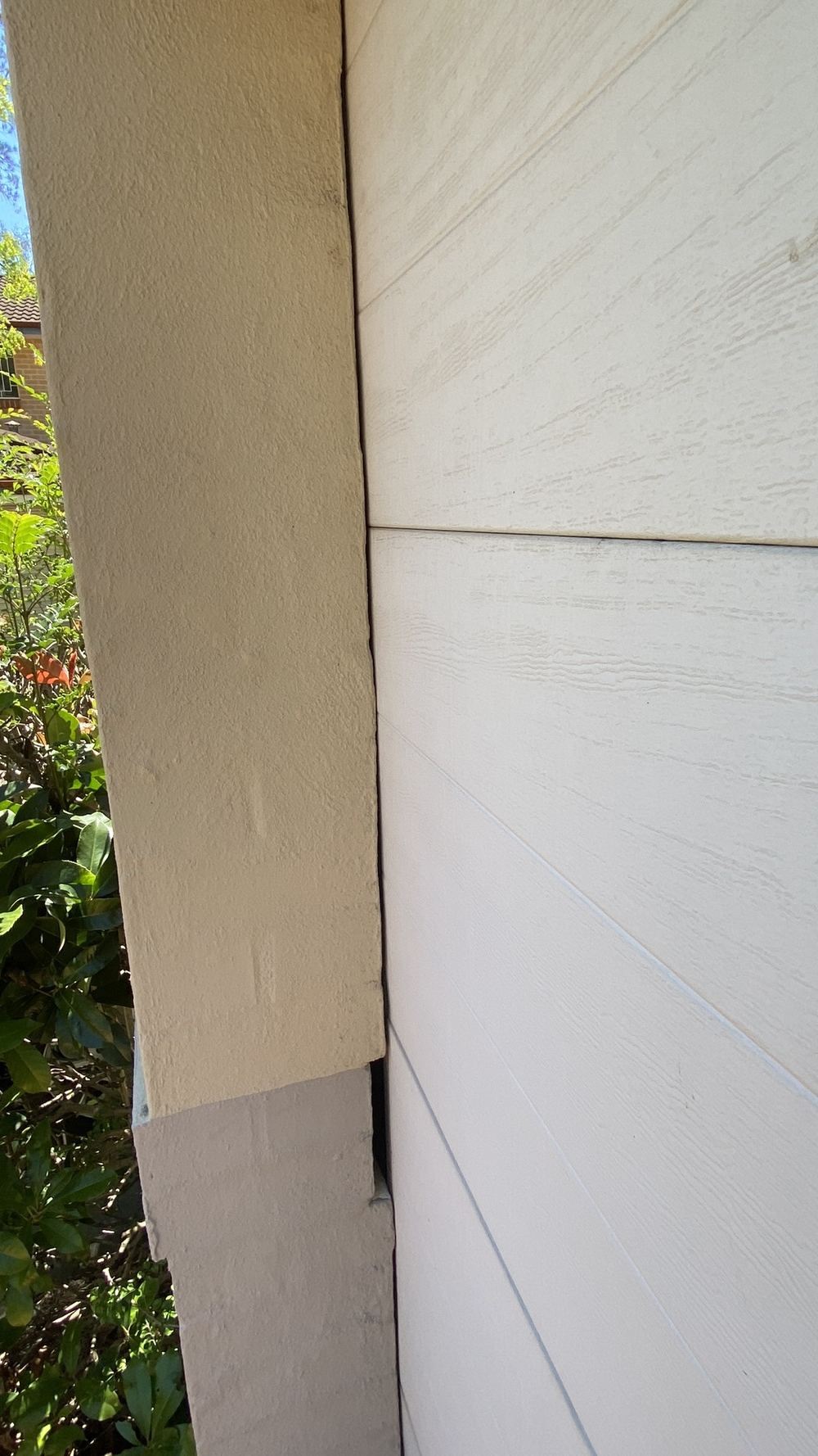Garage door rubbing on the brickwork with no clearance at the track, found during a pre-purchase building and pest inspection in Castle Hill