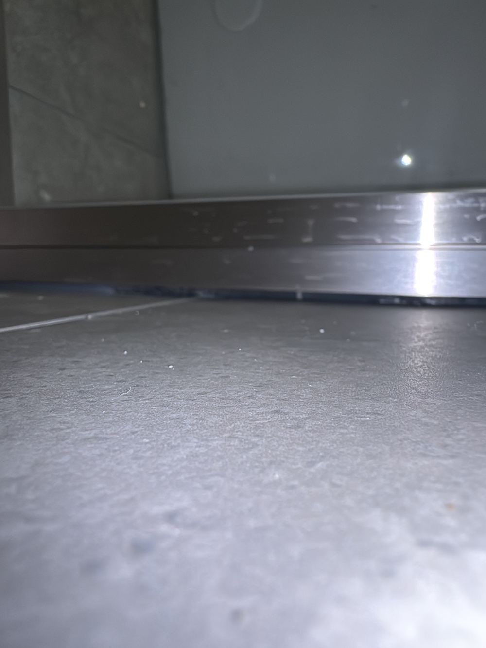 Sealant incomplete at a wet area junction, letting water escape, found during a handover inspection in Castle Hill