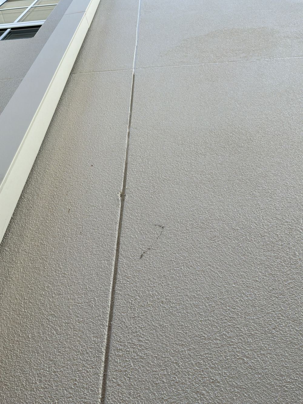 Render carried over a control joint at handover, found during a handover inspection in Castle Hill